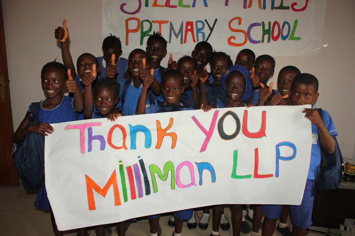 Kids with a banner saying thank you