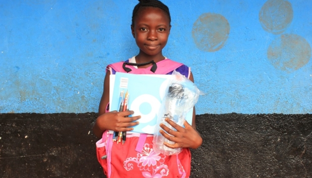 African kid with school supplies