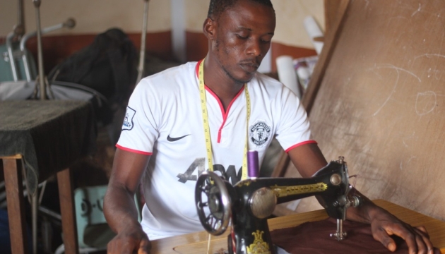 A man sewing