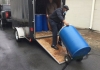 Man pulling a big blue drum