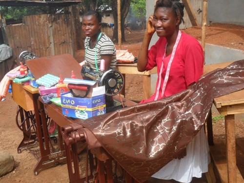 (c) Develop Africa. Across Africa, women are building businesses against the odds. 2 women received tailoring training kits from Develop Africa.