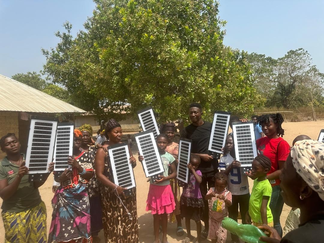 (c) Develop Africa. People of Mgbaikoli village in Sierra Leone received their first-ever solar-powered light.