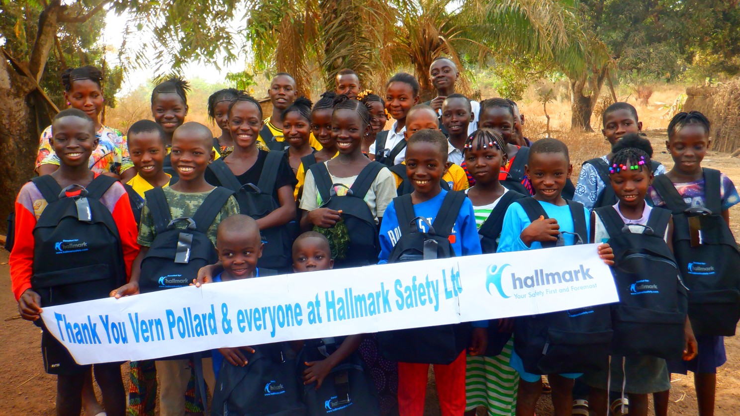 (c) Develop Africa. Students who received a new school bag thanked Pollard and Hallmark Safety Ltd.