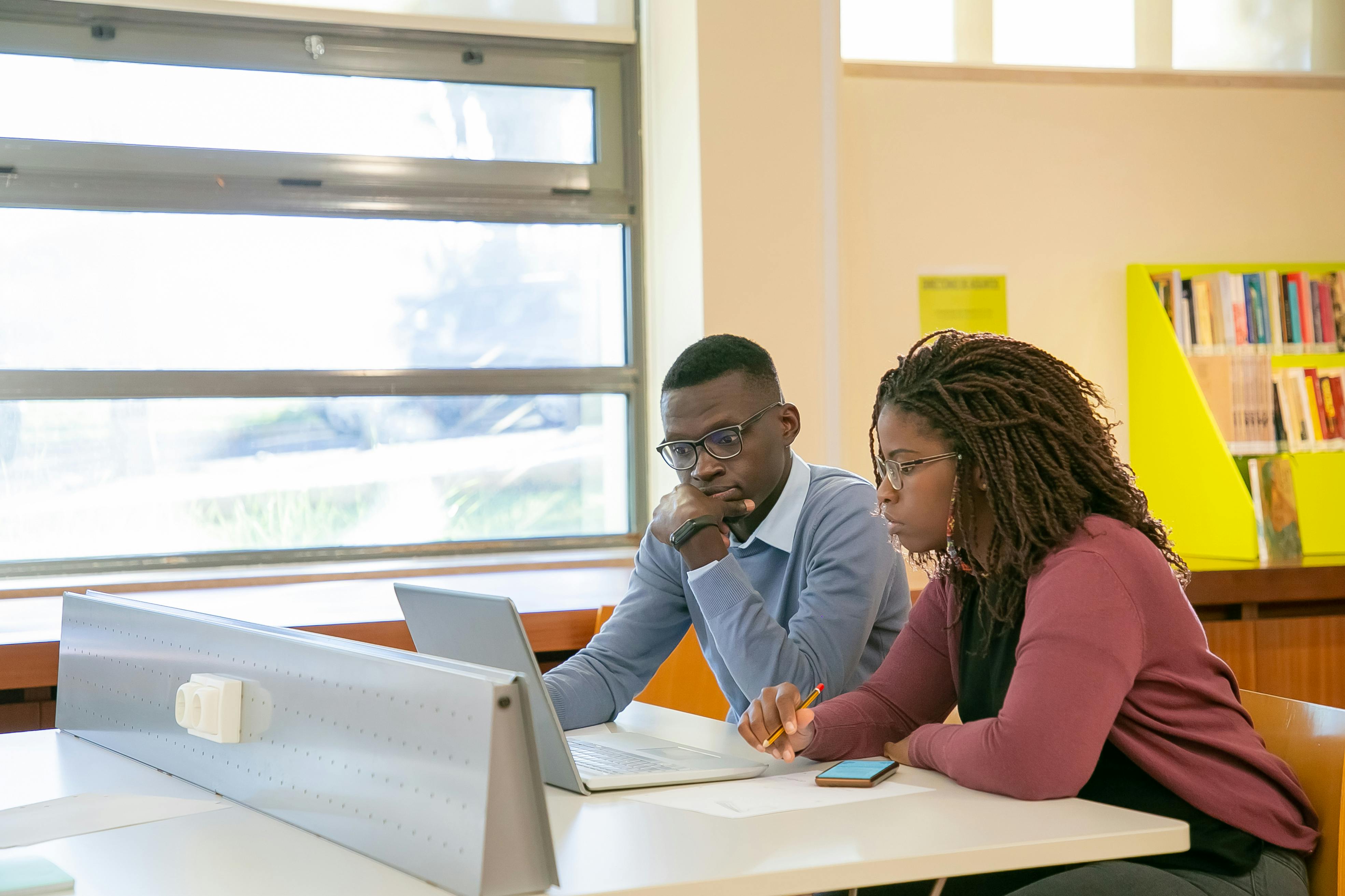 blak couple doing presentation for students in classroom